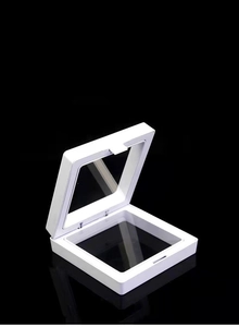 Macro detail of white square PE film floating display case showing elastic membrane texture