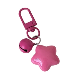 Cute pink star keychain with matching bell and spring clasp on a white background