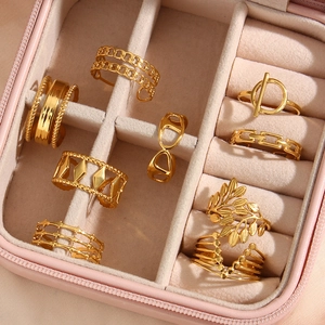 Pink velvet jewelry box filled with eight different styles of 18K gold plated rings