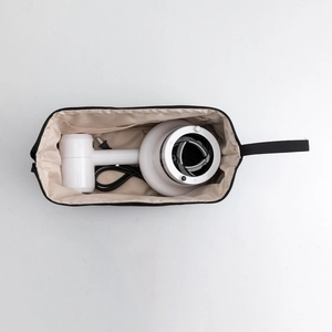 Interior view of travel hair dryer bag showing spacious capacity and inner zipper pocket