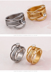 Detail of gold and silver hollowed out fishtail rings with sparkling crystal inlay