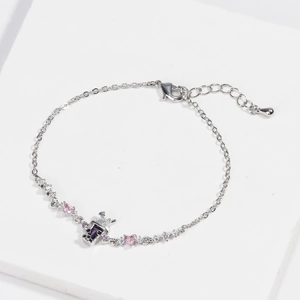Detail of silver chain bracelet with heart zircon and purple bubble tea pendant charm