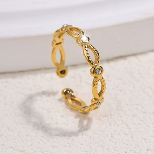 Macro shot of gold hollow oval ring with sparkling cubic zirconia stones