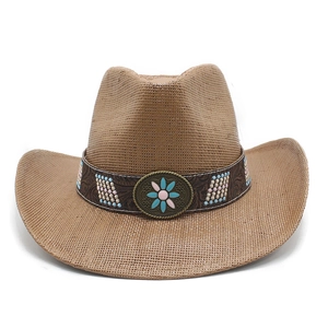 Detail of straw cowboy hat with embossed band, blue beads and vintage floral medal