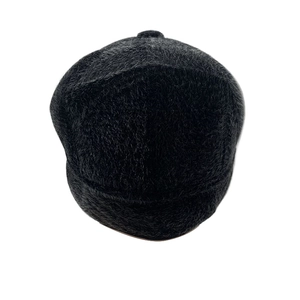 Close-up of black plush faux fur texture on a warm winter flat cap for elderly men