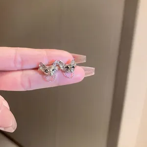 Unique silver cat-shaped stud earrings with chain detail and minimalist metallic design
