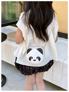 Rear view of child wearing a cute black and white panda cross-body bag with gold chain