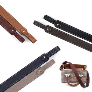 Detail of colorful pebbled PU leather bag straps with white stitching and metal studs