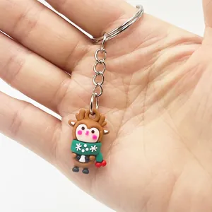 Close-up of a mini Christmas reindeer keychain made of soft silicone held in hand