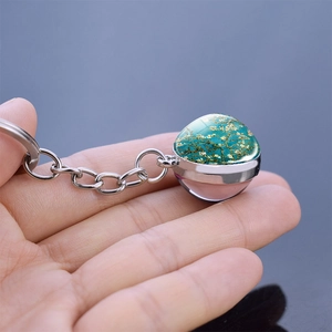 Metal keychain featuring a glass ball pendant with Van Gogh almond blossoms art design