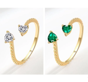 Detailed macro view of heart-shaped zircon stones on gold-plated open rings