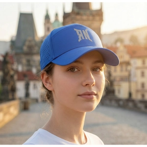 Blue breathable baseball cap featuring laser-cut side vents and PXG logo detail