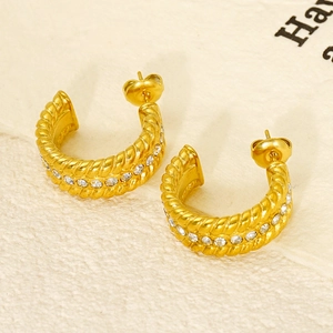 Gold twisted C-hoop earrings with sparkling zircon stones and a classic woven texture