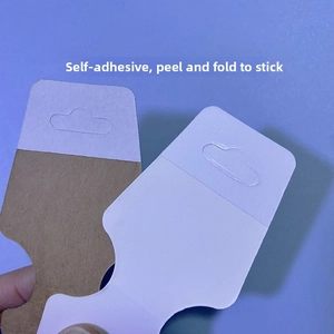 Macro view of self-adhesive jewelry cards for necklaces and hair ties in kraft and white