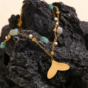 Detail of 18K gold-plated double-layer anklet with natural stone and fishtail pendant