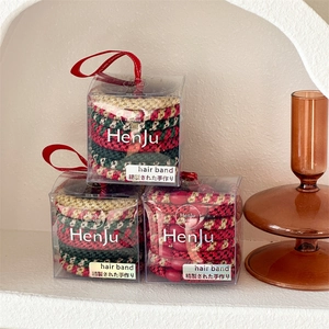 Close-up of high-elastic braided hair ties set in gift box with festive Christmas colors