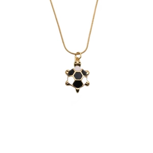 Gold plated turtle necklace pendant with black and white geometric pattern on white background