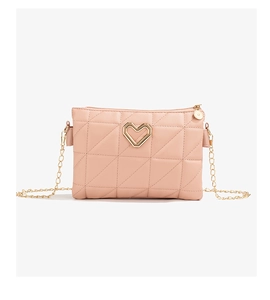 Pink quilted crossbody bag with gold heart clasp and chain strap detail view