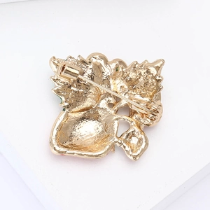 Detailed back view of the golden alloy strawberry brooch showing the secure pin fastener