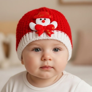 Detail of red and white baby knit hat featuring a cute snowman decoration for Christmas