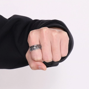 Close-up of vintage punk dragon scale steel ring with crystals on male hand