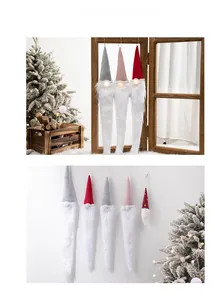 Close-up of LED glowing Christmas gnomes with knit hats and plush beards for decor