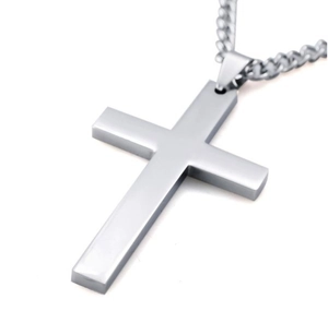 Close-up of minimalist silver cross pendant with metallic chain on white background