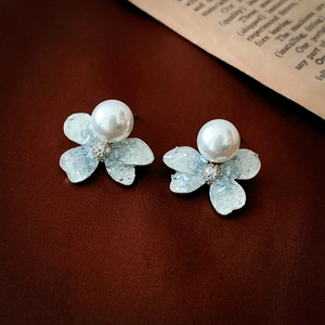 Elegant floral stud earrings featuring crystal petals and pearl center with zircon accents