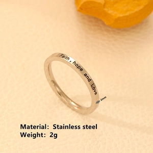 Macro detail of silver stainless steel ring band engraved with Faith Hope and Love