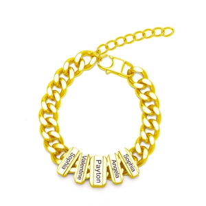 Detail of gold Cuban link bracelet with five personalized engraved name plates on white background