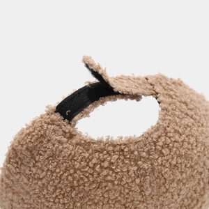 Detail of adjustable velcro strap on warm brown teddy fleece baseball cap for autumn