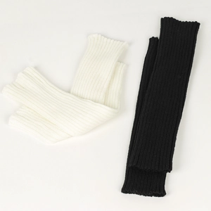 Detailed knit texture of black and white slouch socks in soft ribbed fabric