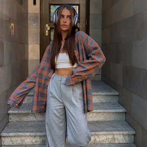 Détail d'une chemise vintage à carreaux orange et gris avec manches longues