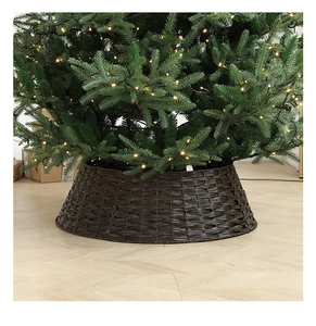 Detail of dark brown hand-woven Christmas tree collar with warm holiday lighting