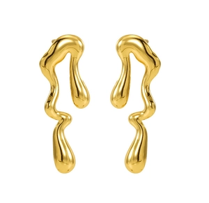 Close-up of golden irregular liquid metal earrings with a polished mirror finish