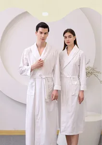 Detailed waffle texture of white summer bathrobe with soft cotton fabric and waist tie