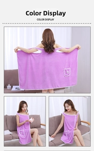 Detailed view of a purple coral fleece wearable bath towel with a bow pocket and white piping