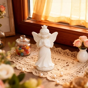 Elegant white angel figurine in prayer pose with crown and wings for home decor