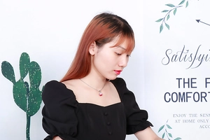 Model wearing a silver necklace with a sparkling red round crystal pendant close-up