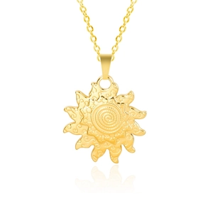 Close-up of golden sun pendant with spiral texture and intricate cloud patterns