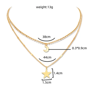 Detailed view of layered gold necklace with rhinestone moon and star pendant measurements