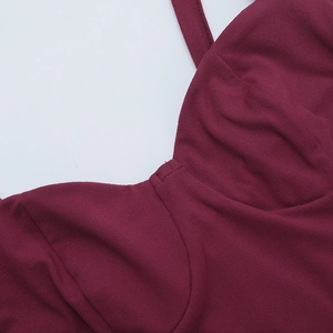 Detailed close-up of burgundy lace V-neckline stitching on a backless slip dress