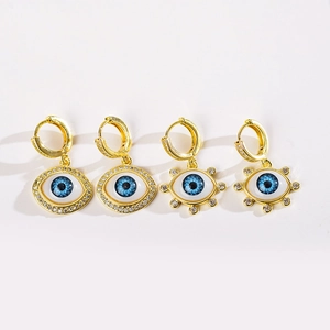 Golden evil eye dangle earrings with blue stones and crystals in four distinct designs