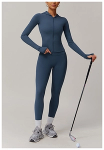Close-up of greyish blue zippered yoga hoodie featuring thumbhole sleeves and high waist pants