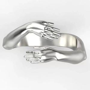 Detailed view of polished silver hug ring showing 3D arms wrapping around the finger