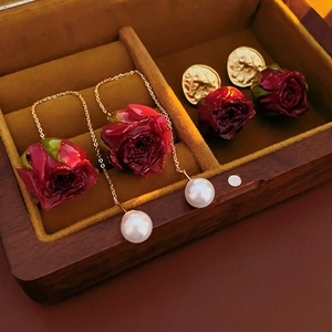 French retro preserved rose earrings with long tassels and pearls in a luxury jewelry box