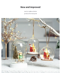 Close-up of hanging glass dome Christmas ornaments with Santa and Xmas miniature scenes