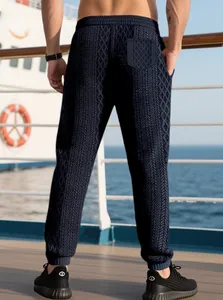 Men's navy waffle knit joggers featuring a textured diamond pattern and ribbed cuffs