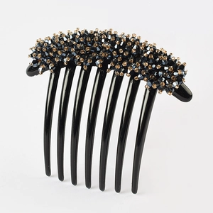 Detailed view of a 7-tooth hair comb featuring elegant black and gold faceted crystal beads