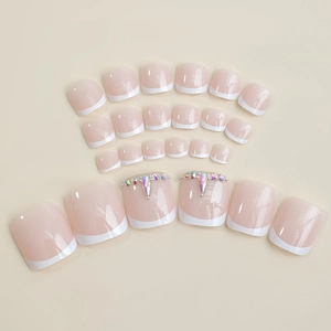 Sparkly rhinestone press-on toenails in nude pink with white French tip design